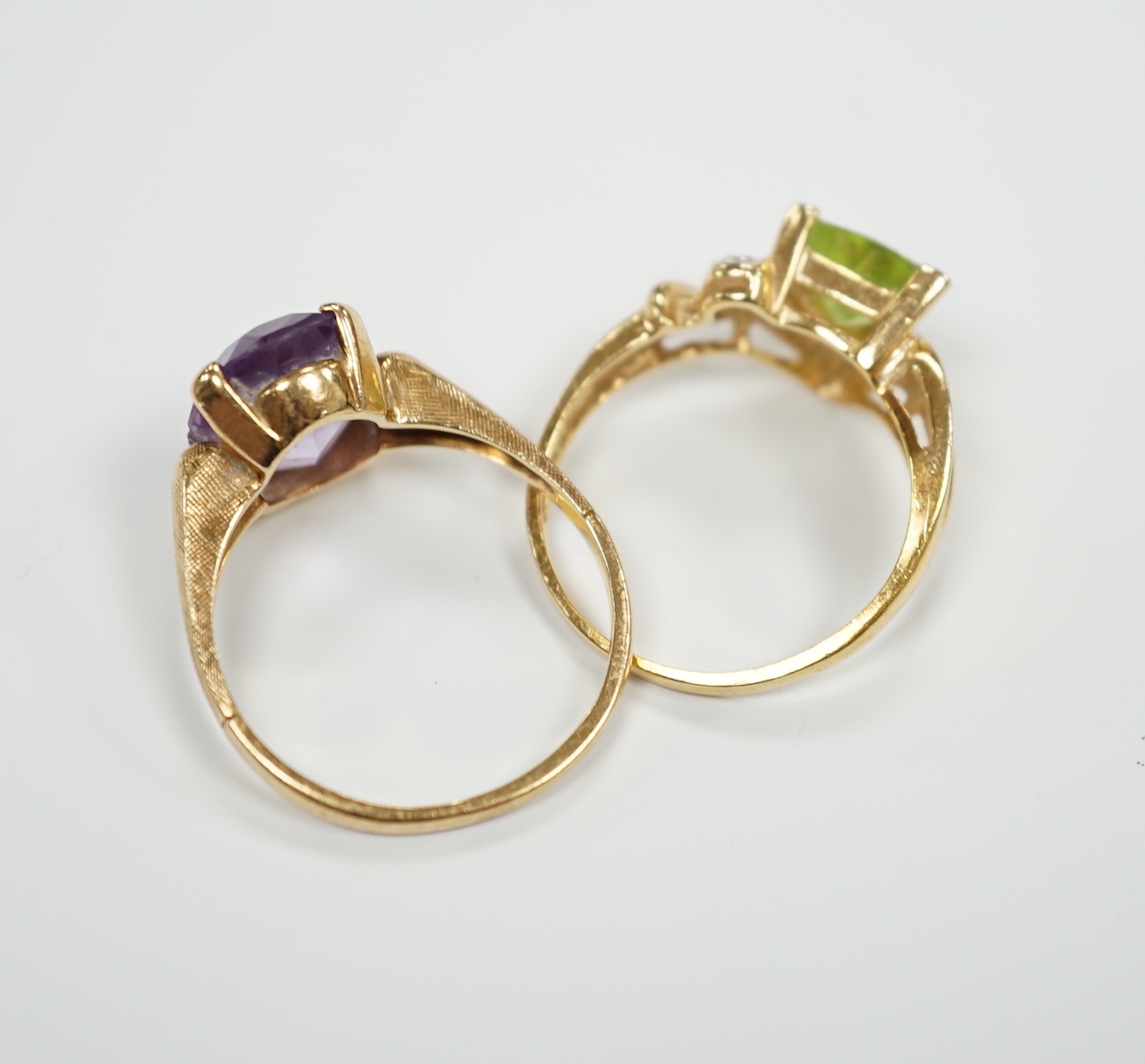 Two modern 14k and gem set dress rings, including amethyst, size P/Q, gross weight 6 grams.